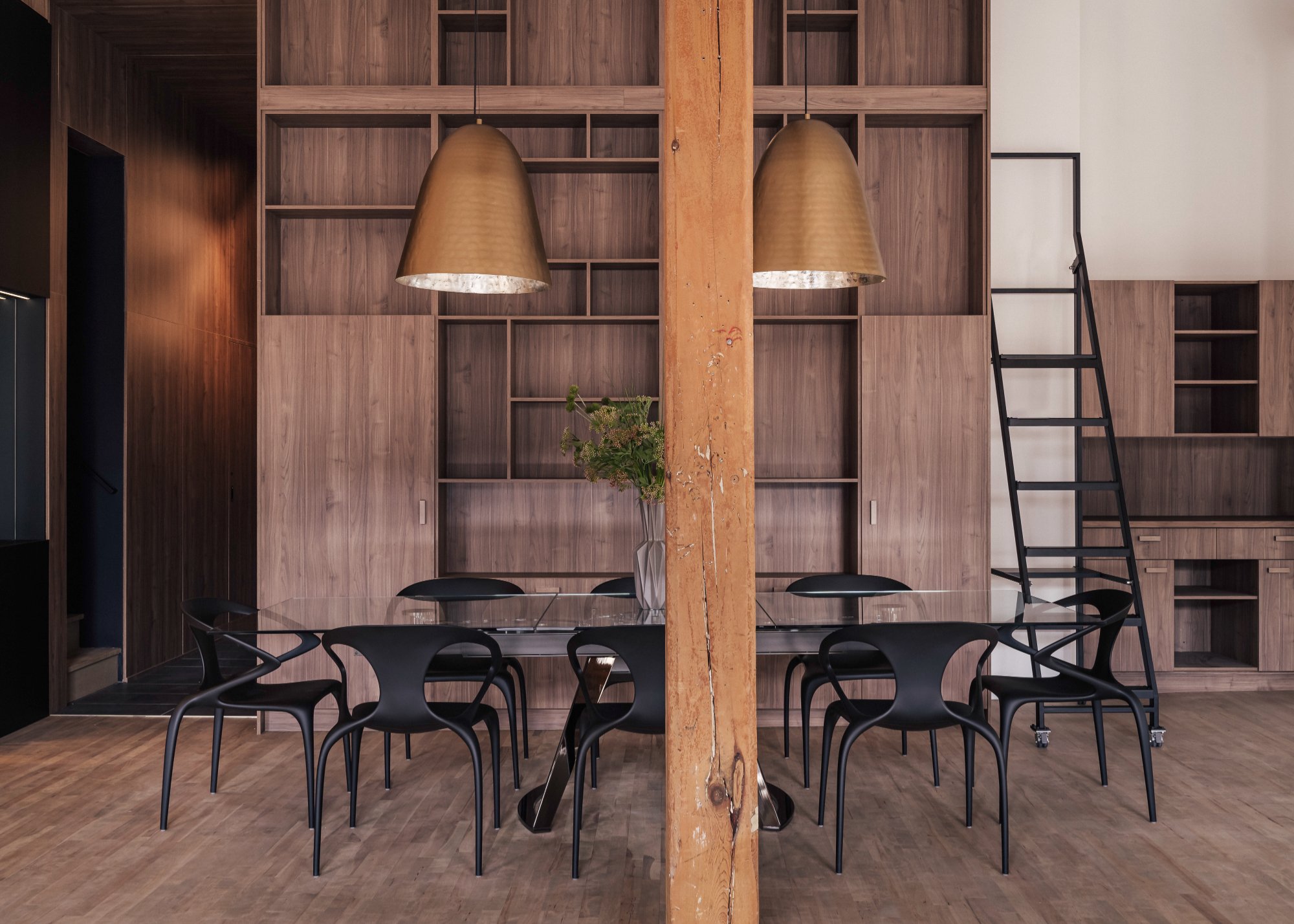 Wellington Loft — Walnut built-ins with brass pendants and custom dining table